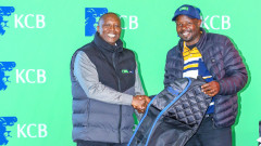 KCB Bank Regional Operations Manager- Rift, Stephen Mosong, presents a prize to the Overall winner at Eldoret Club, Amos Butit. PHOTO/COURTESY
